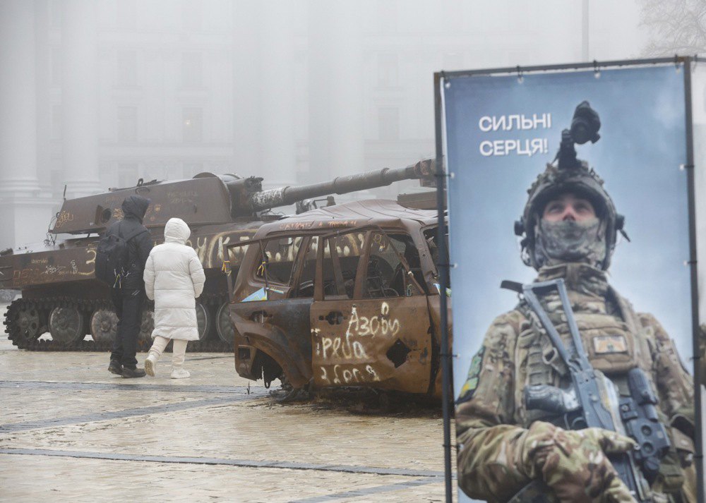 Люди розглядають знищену російську військову техніку й пошкоджену українську цивільну техніку, виставлену на площі біля Михайлівського собору в центрі Києва, 9 грудня 2024 р.