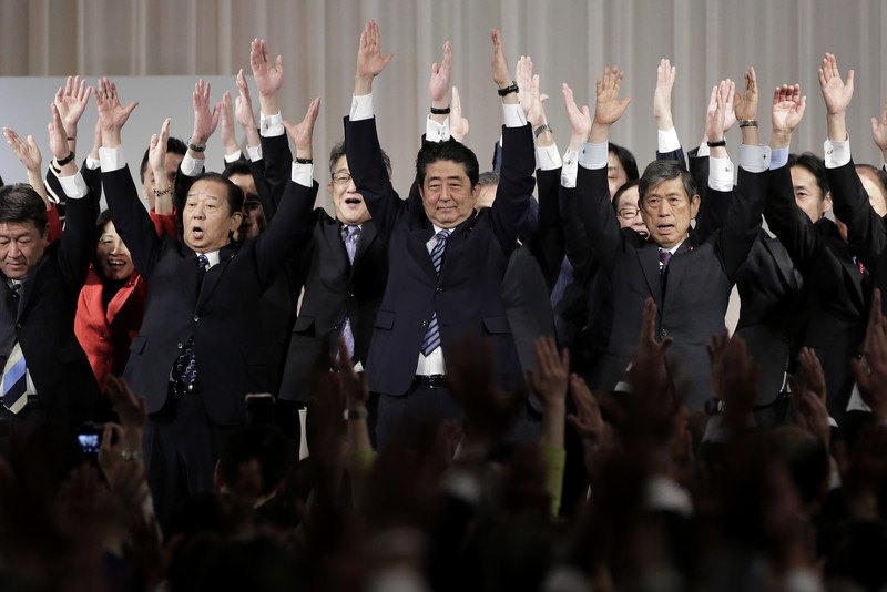 Прем’єр-міністр Японії та президент правлячої Ліберально-демократичної партії Сіндзо Абе (в центрі) вітається з членами партії на щорічному з’їзді партії у Токіо, 5 березня 2017 року