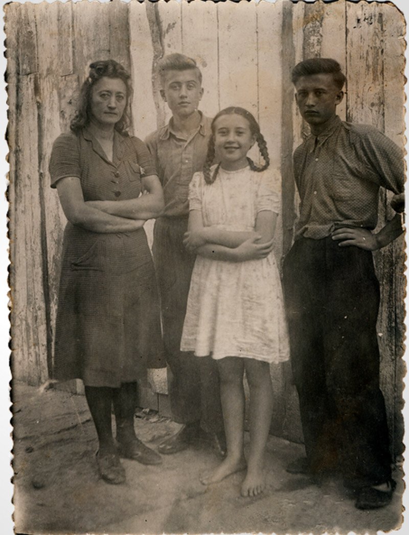 Марія Гулей з дітьми Олегом, Іваном та Мартою під час утримання на пересильному пункті, місто Борислав у Львівській області,
1950 рік