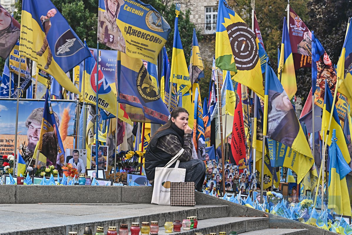 Жінка біля Меморіалу героїв на майдані Незалежності.