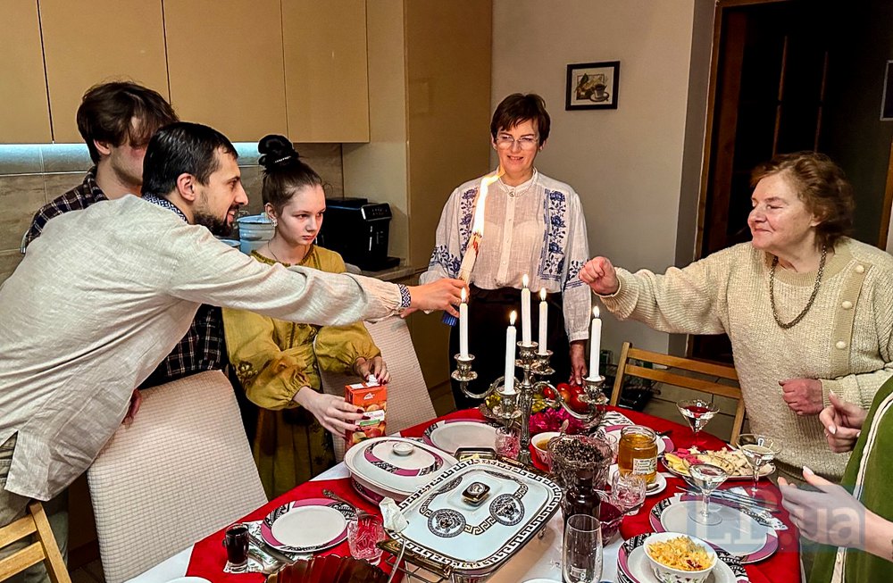 Родина запалює свічку моливу перед початком трапези на Святвечір.