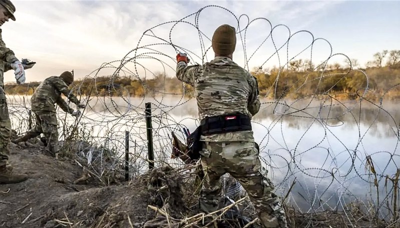 Військові розгортають стіну з колючого дроту вздовж річки річки Ріо-Гранде на кордоні з Мексикою у штаті Техас 