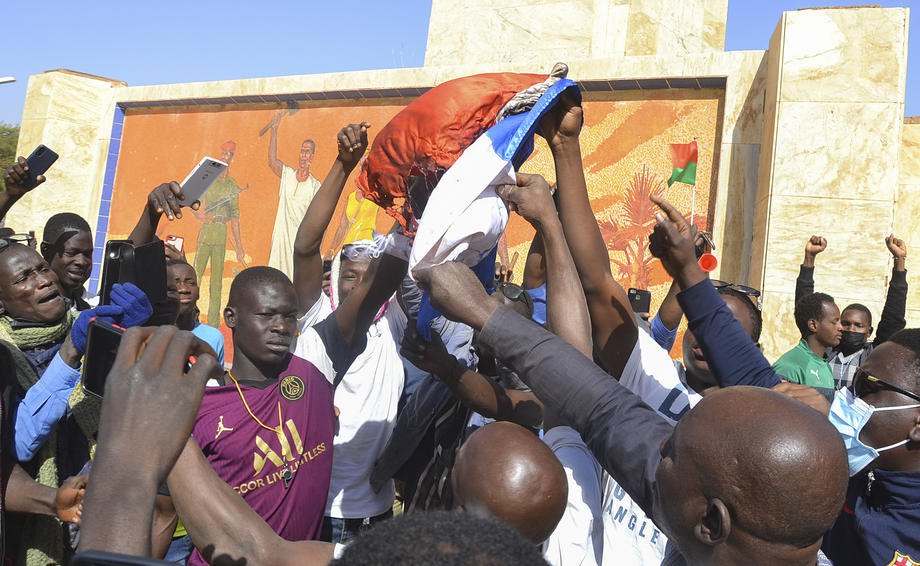 Протестующие, поддерживающие организаторов военного переворота, сжигают французский флаг в Уагадугу, Буркина-Фасо, 25 января
2022 года.