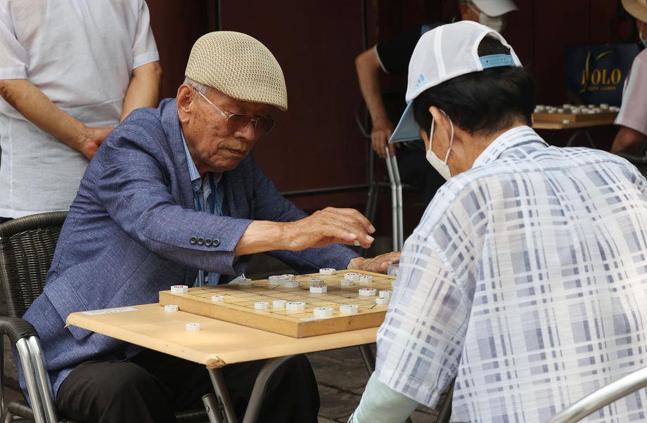 Чоловіки грають у шахи чангі в парку Сеула, Південна Корея, 1 липня 2021 р.