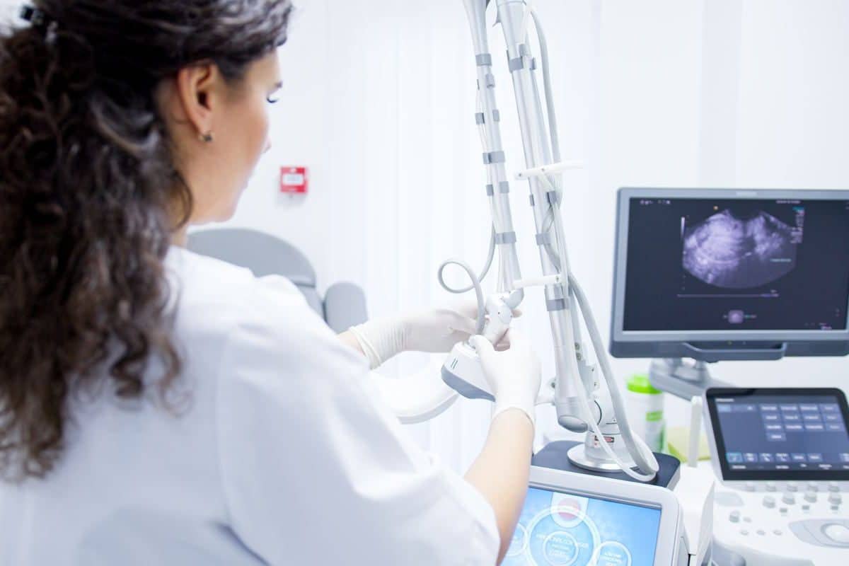 An obstetrician-gynecologist performs ultrasound during the consultation