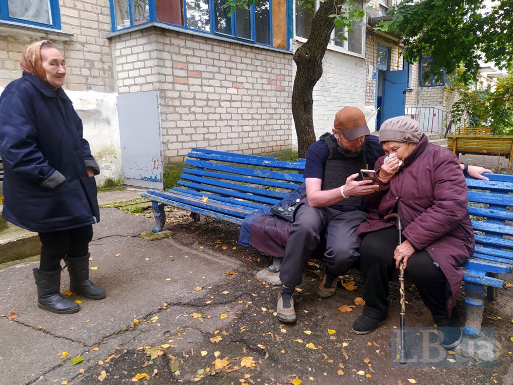 Волонтер Олександр Кусайко переконує місцеву жительку Олену Вікторівну за дорученням її сина евакуюватись до Харкова.