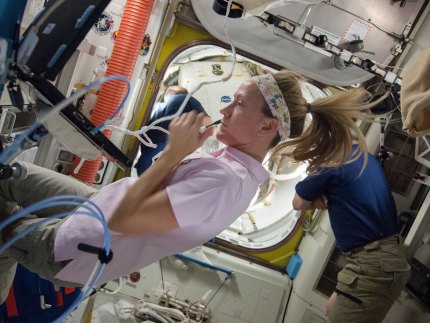 Астронавт НАСА Карен Ниберг помогает коллегам готовиться к выходу в окрытый космос