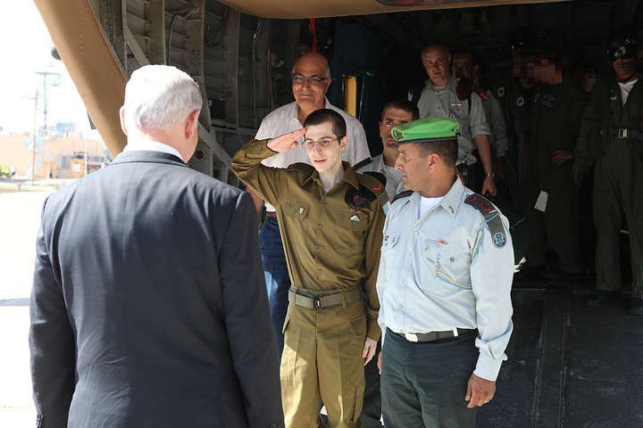 Corporal Gilad Shalit greets Israeli Prime Minister Benjamin Netanyahu after his release from captivity, 18 October 2011