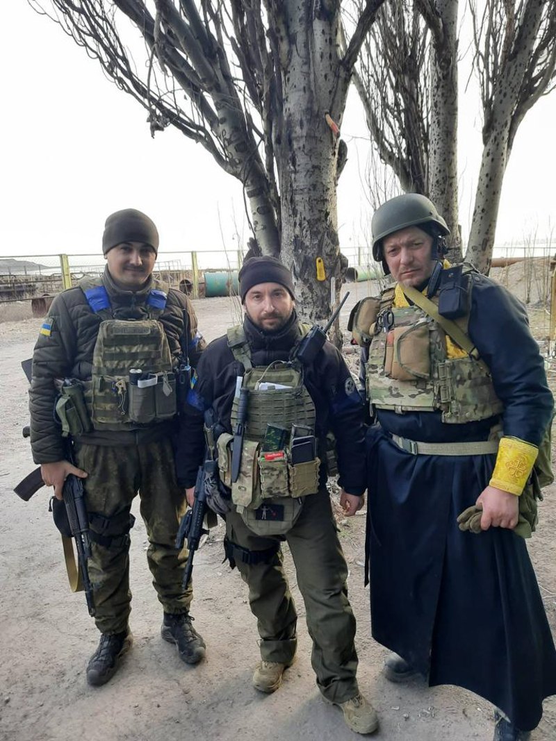 Chaplain Vasyl Fedorenko (right) and Petro Melnyk (centre) during service