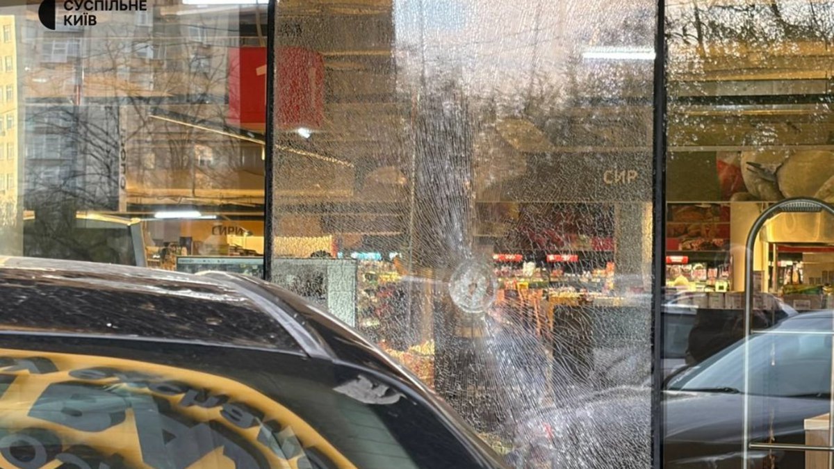 A shop window with bullet holes