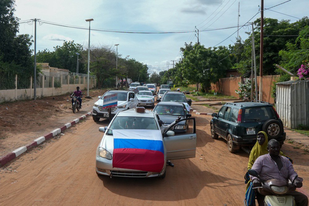 Supporters of General Abdourahmane Tchiani, the chief of the presidential guard who declared himself Niger's new leader after a coup d'état, with Russian flags during protests in Niamey, Niger, August 2023