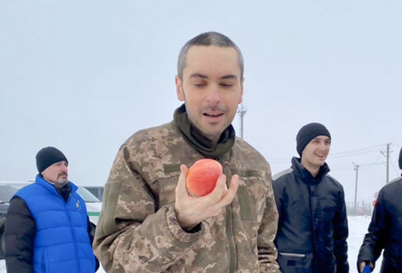 Maksym Kolesnikov, a former restaurateur and Ukrainian Armed Forces veteran, immediately after his release from Russian captivity, looking at a fresh apple for the first time in 11 months.