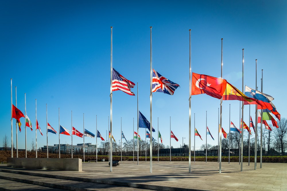 State flags of NATO member countries in front of the organisation's headquarters in Brussels.