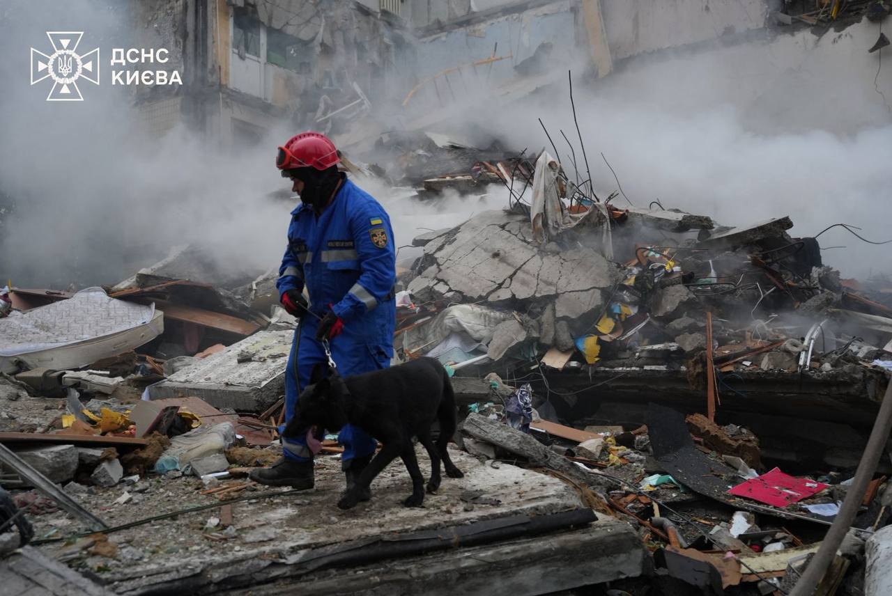 Rescuers working at the site of the Russian attack on Kyiv, 31 July