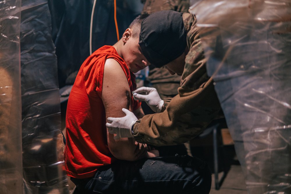  A medic provides medical aid to a wounded soldier in an Azovstal bunker.