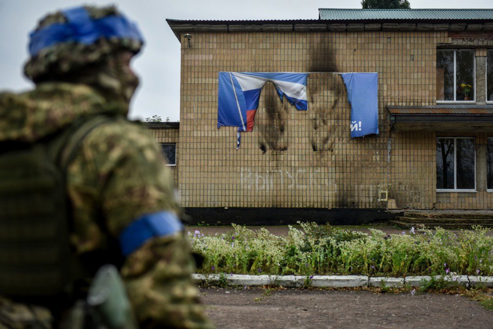 A burnt Russian flag banner in a liberated settlement in Kharkiv Region, 18 September 2022