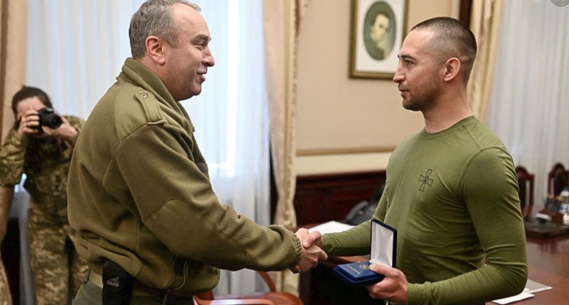 The head of the Cherkasy Department of Military Adminisytation Igor Taburets presents a reward to Roman Gribov, the discharged serviceman from Zmiyiny island, the author of the famous phrase &quot;Russian warship, go fuck yourself &quot;, Cherkasy, 29 March 2022 