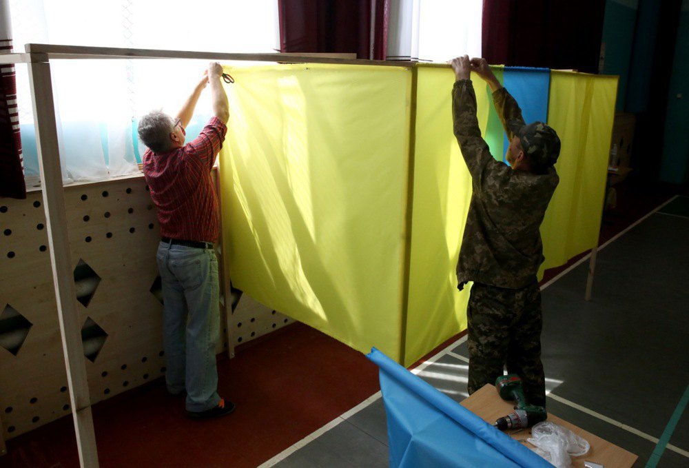 Members of the election commission are preparing the polling station for voting in the village of Pidhirtsi, 20 April, 2019