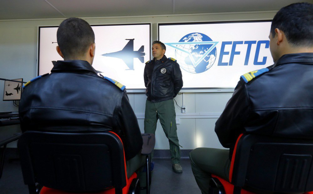 The commander of the European F-16 Training Centre (name withheld for security reasons) talks to student pilots at the air base in Borca, Romania, 13 November 2023.