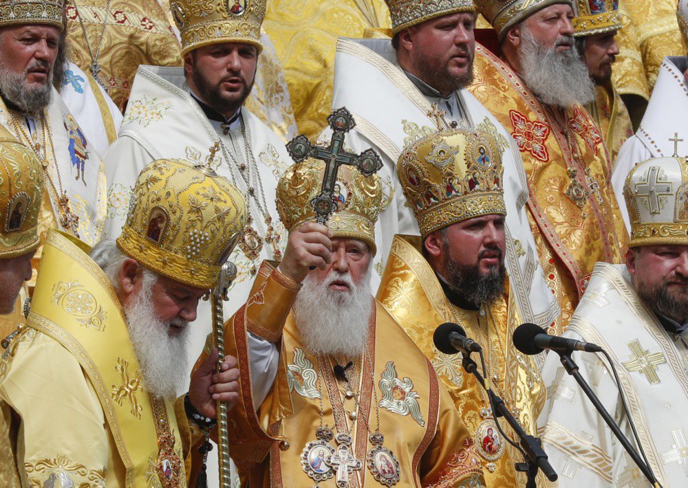 Patriarch Filaret (centre), primate of the Ukrainian Orthodox Church of the Kyiv Patriarchate, blesses the faithful during a prayer service on the occasion of the 1030th anniversary of the baptism of Kyivan Rus on Volodymyrska Hill in Kyiv, 28 July, 2017