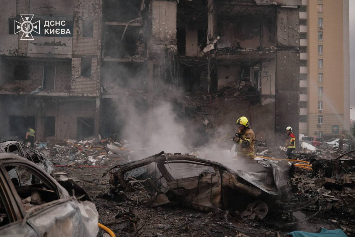 Rescue workers at the scene of the shelling in Kyiv