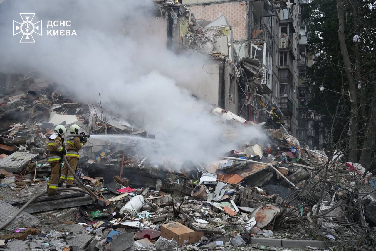 Rescuers working at the site of the Russian attack on Kyiv, 31 July