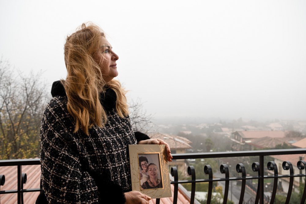 Maria Cavallaro holds a photo of herself with Evelina