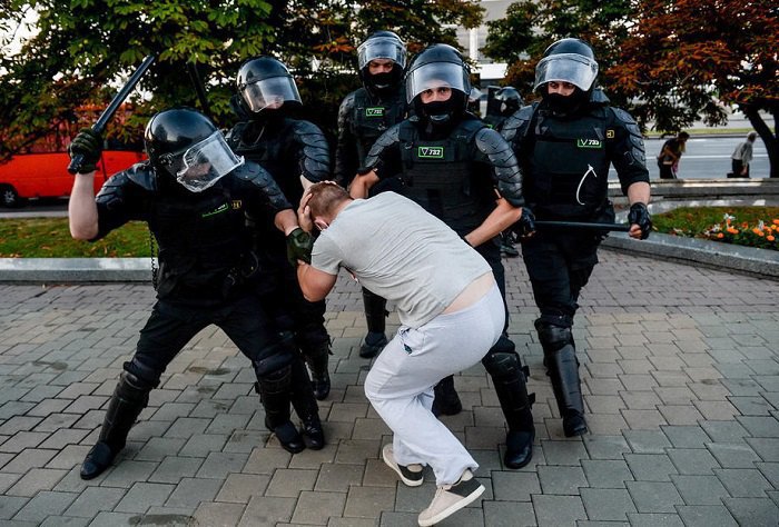 Police detain demonstrators during a protest