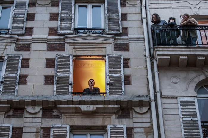 French tenor singer Stephane Senechal sings at his window for the inhabitants of his street in Paris, France, 21 March
2020