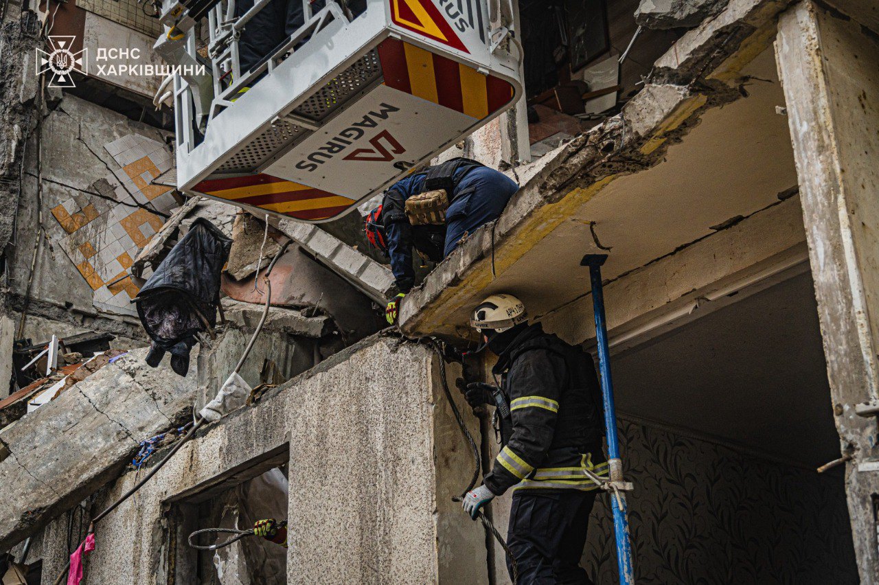 Rescuers work at the site of shelling in Kharkiv