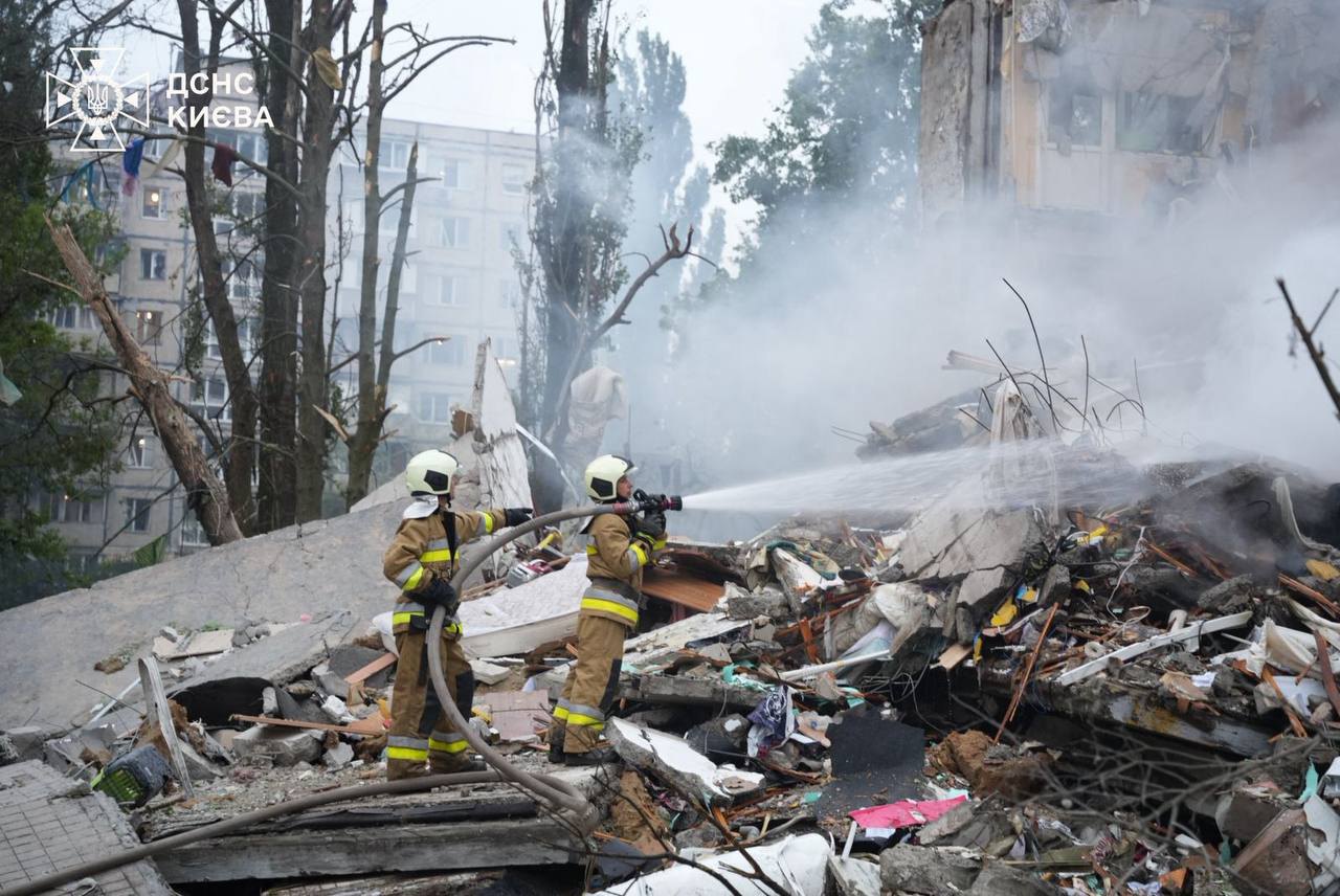 Rescuers working at the site of the Russian attack on Kyiv, 31 July