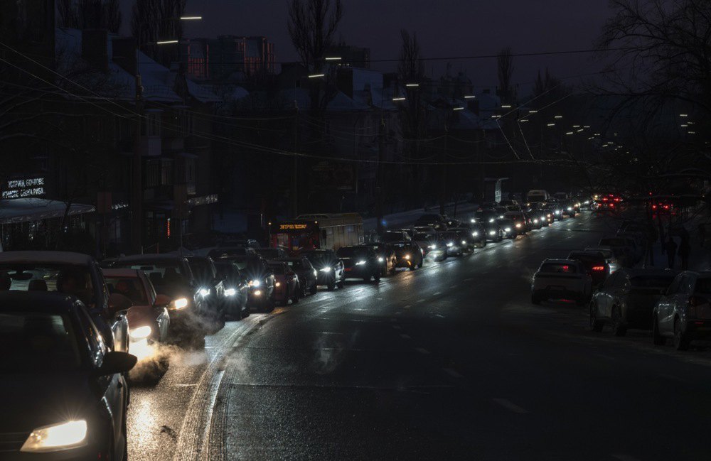 Cars drive along a darkened street, Kyiv, 20 January 2026