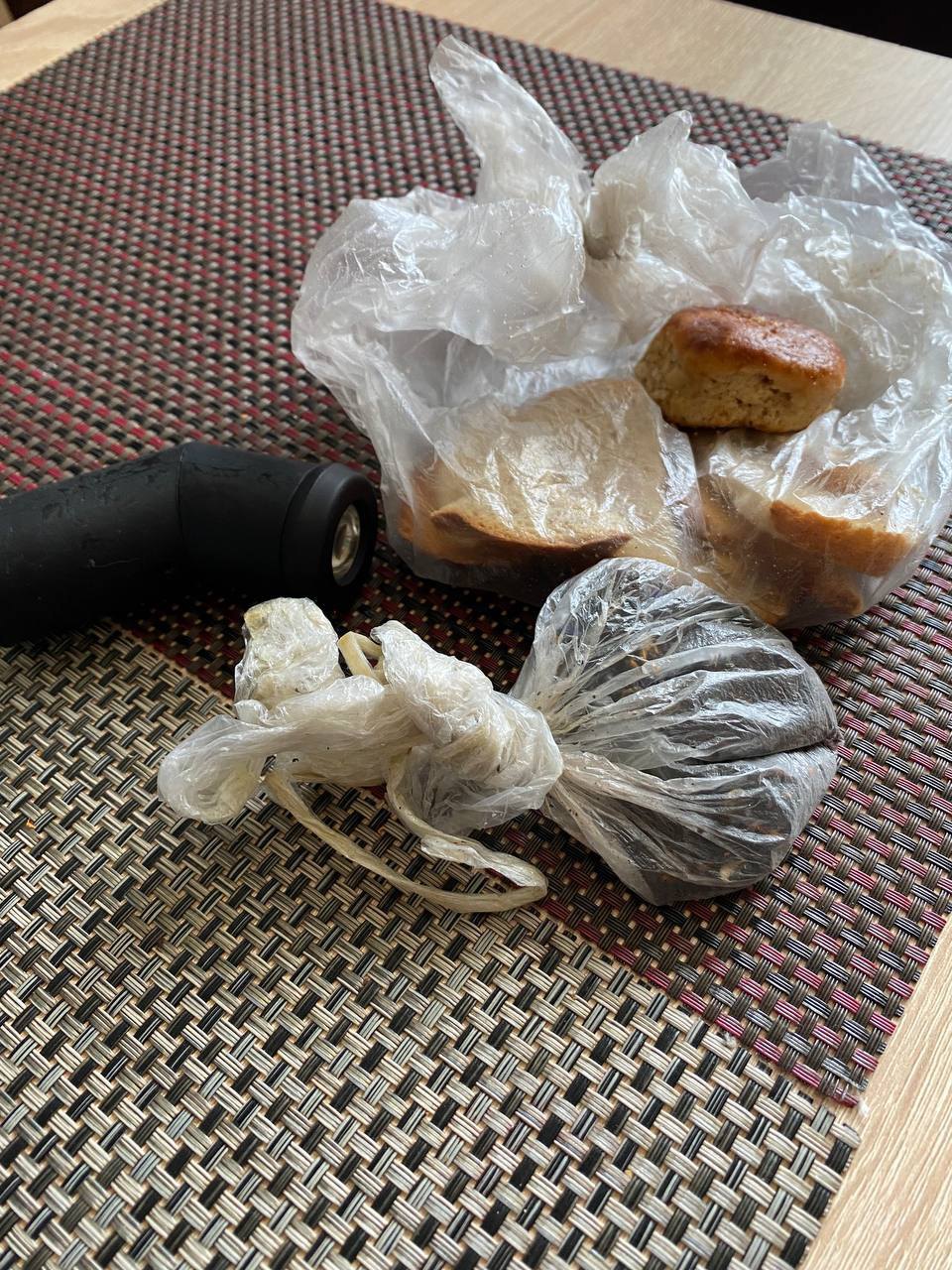 Dry bread, flashlight, and homemade cookies that Karyna, Yulia, and their parents cooked in Mariupol.