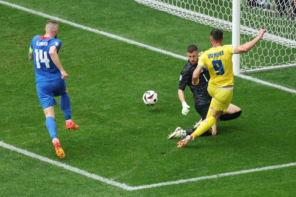 Roman Yaremchuk (right) scores the winning goal against Dubravka in the Euro 2024 match between Slovakia and Ukraine