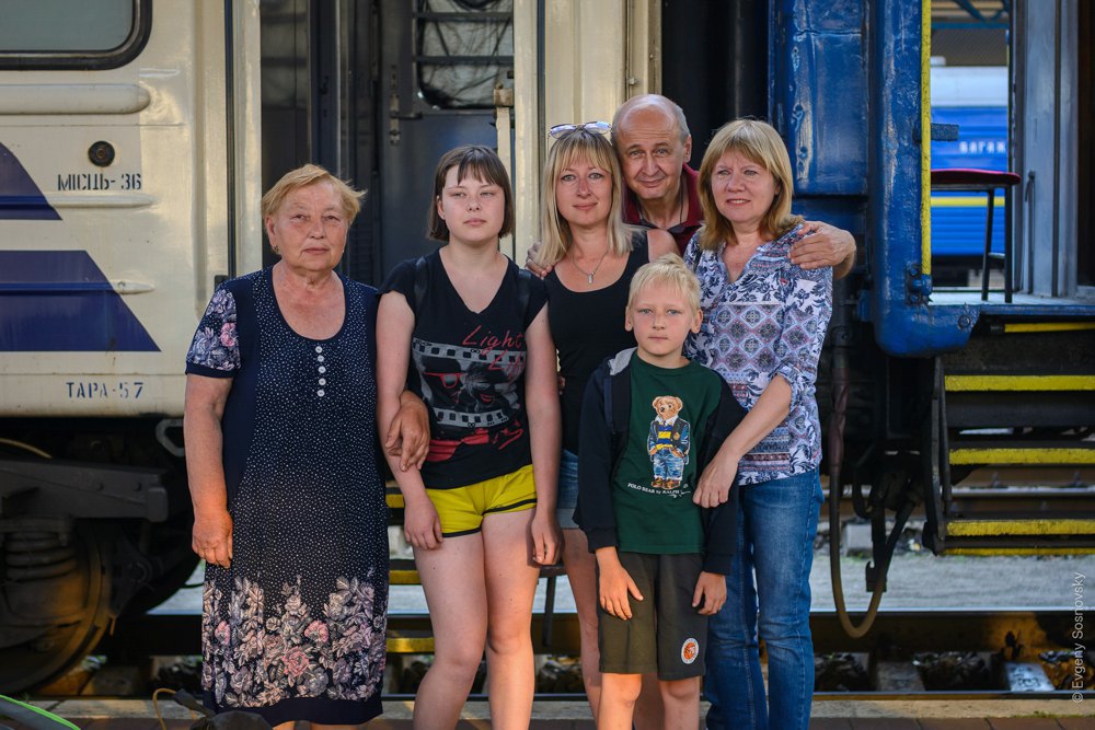 Olena (centre) with her son, daughter and mother (left) on arrival in Kyiv