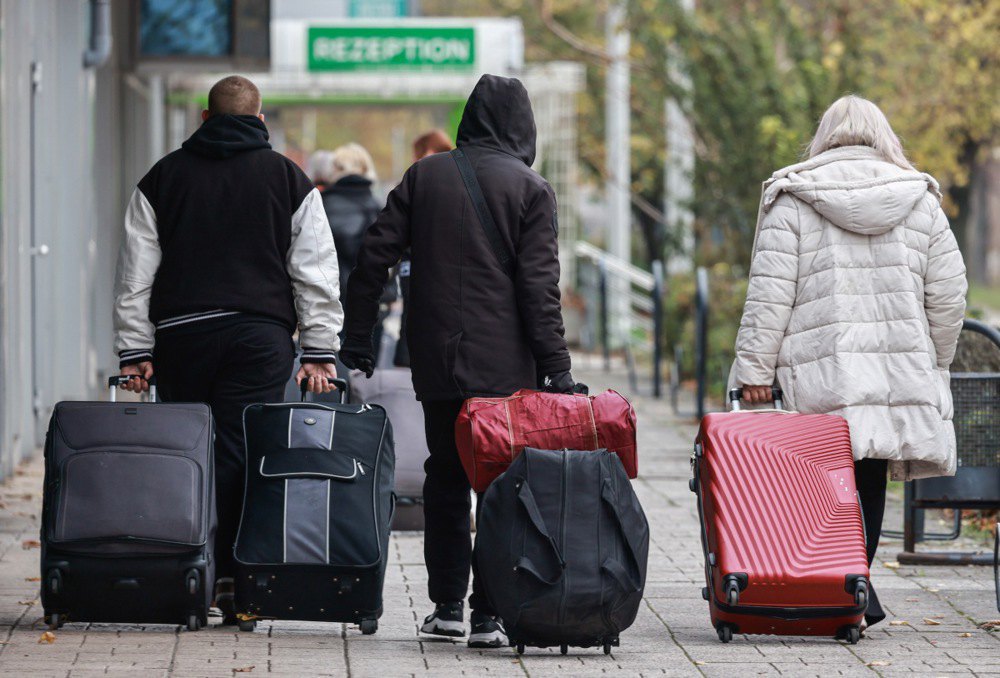 Migrants with suitcases near the Grand City Hotel Berlin, 11 November 2024. Refugees, including those from Ukraine, have moved to Berlin from a reception centre in Tegel.
