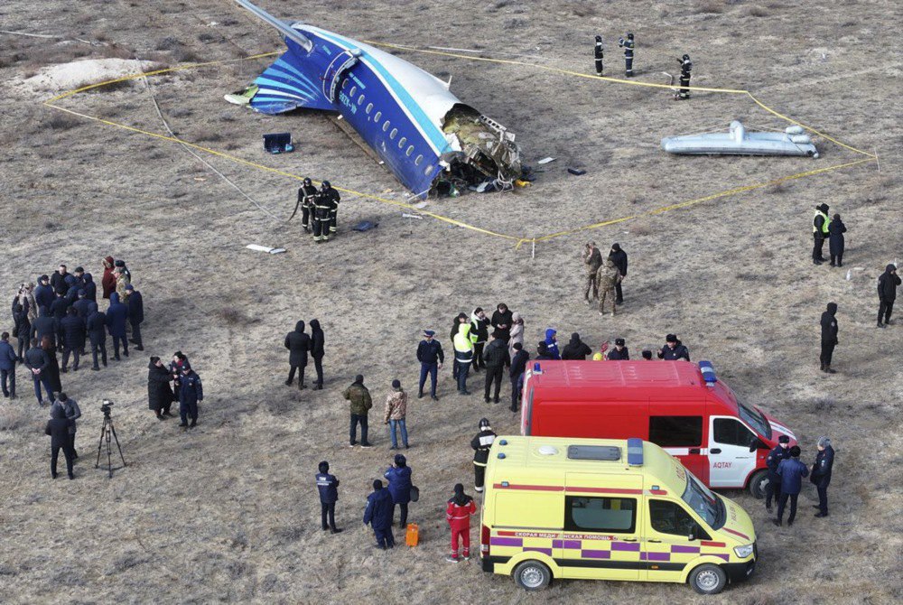 Emergency specialists work at the crash site of the Embraer ERJ-190AR passenger plane of Azerbaijan Airlines flying from Baku to Grozny near Aktau, Kazakhstan, 25 December 2024.