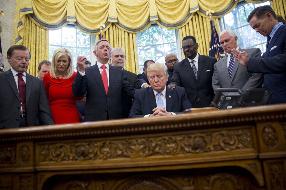  US President Donald Trump prays with US religious leaders after signing a proclamation declaring a day of prayer for the victims of Hurricane Harvey in Washington, DC, 1 September 2017.