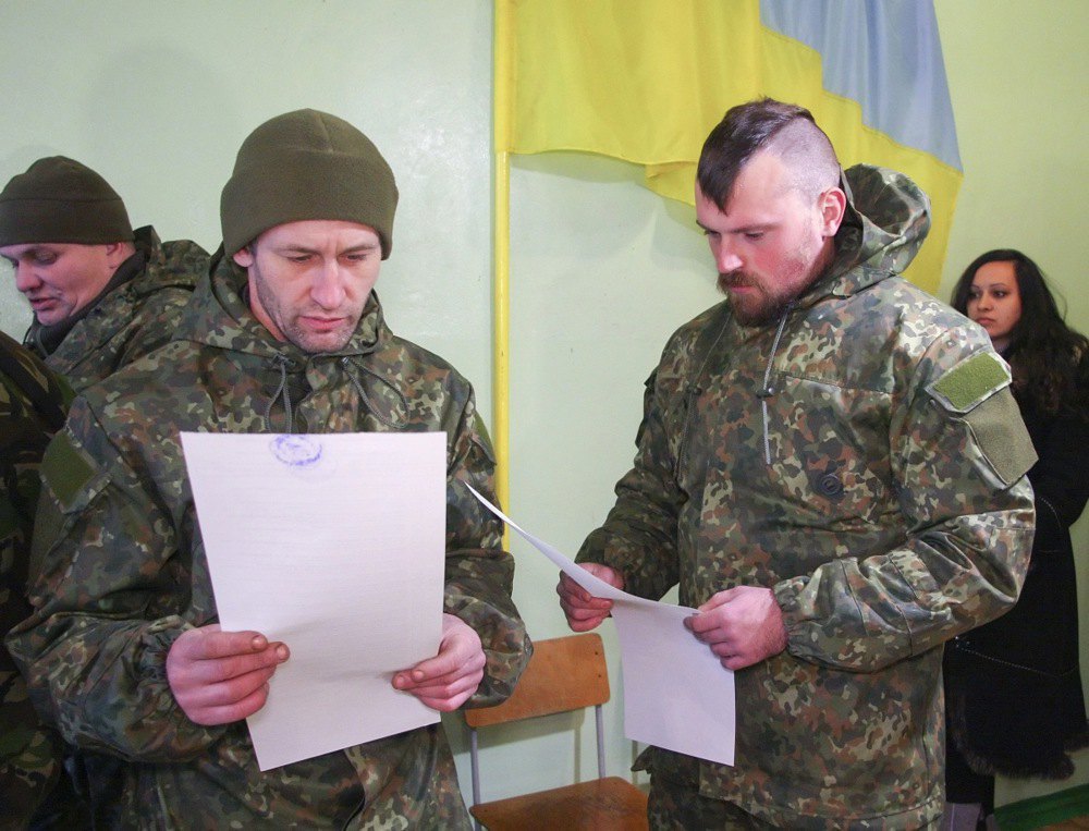 Military personnel at the polling station during voting in the parliamentary elections, Mariupol, 26 October, 2014.