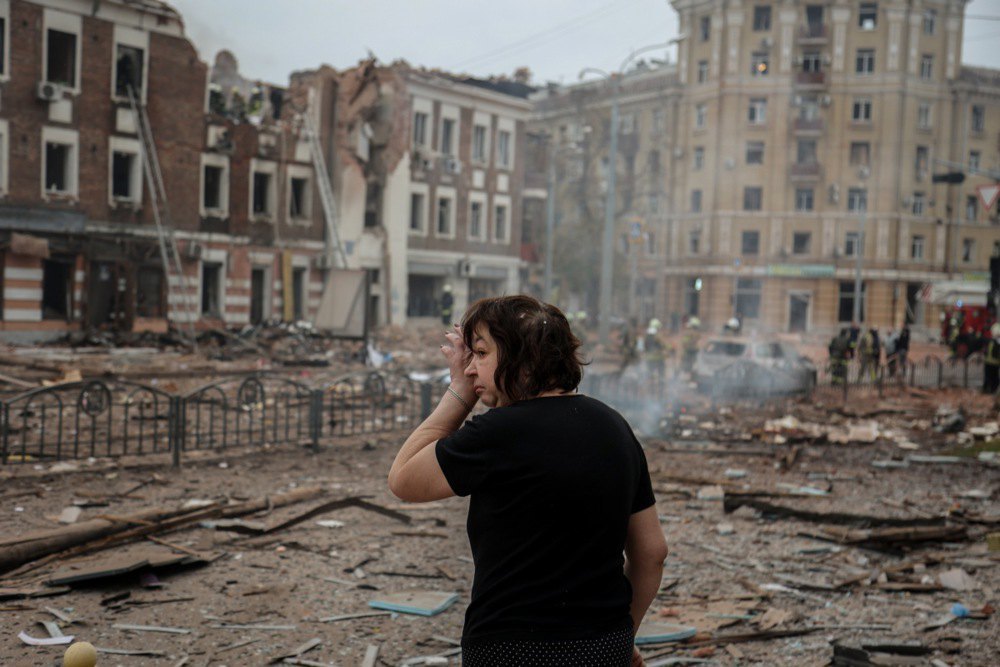 A woman at the scene of destruction after the shelling of Kharkiv.