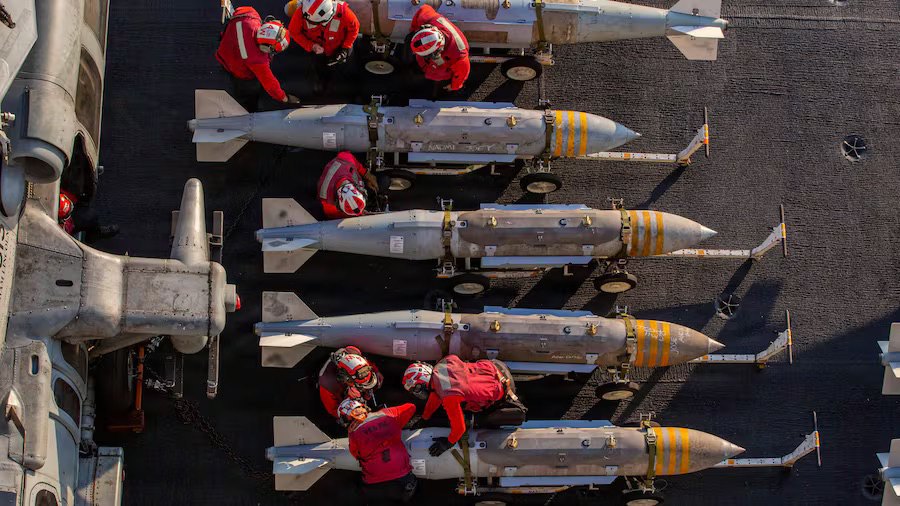  US Navy sailors at work on deck of American amphibious assault ship USS Abraham Lincoln during Operation Epic Fury