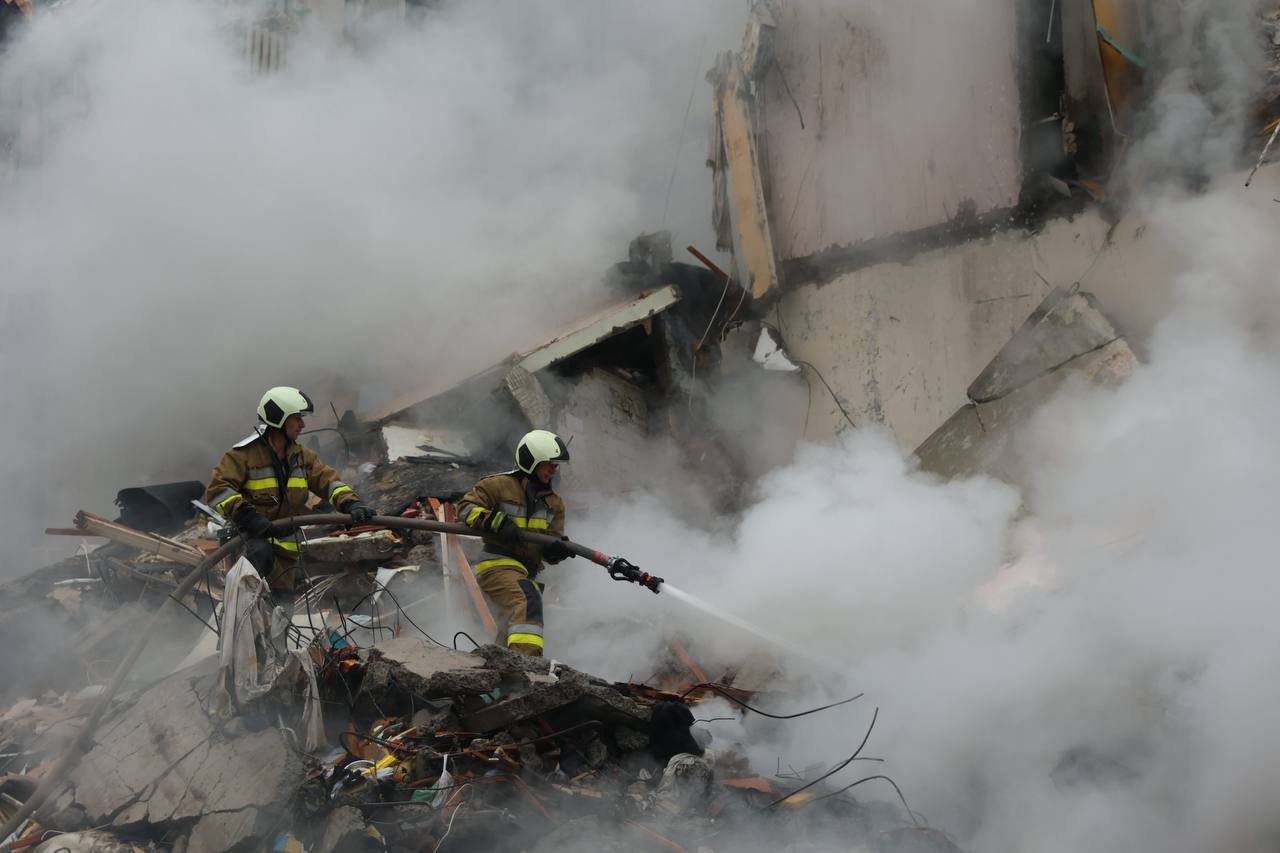 Rescuers working at the site of the Russian attack on Kyiv, July 31