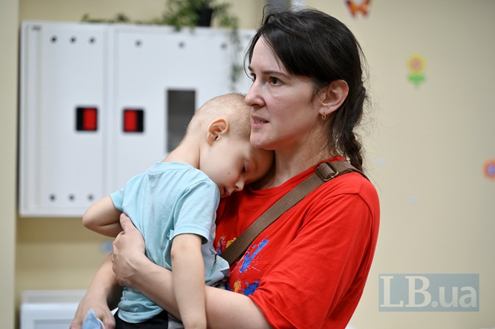 Kateryna and her two-year-old son Maksym wait for the second alarm in the shelter of Okhmatdyt