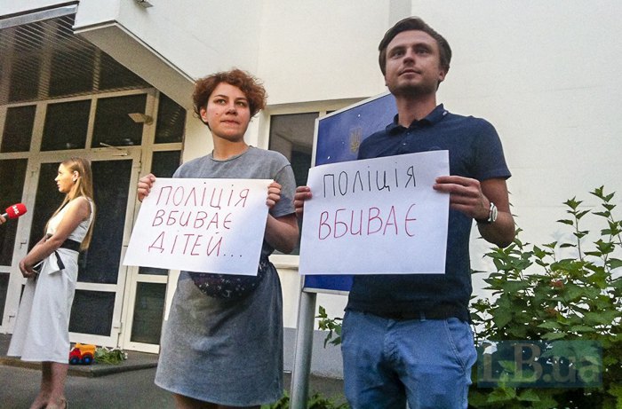 The posters read &quot;Police kill...&quot; and &quot;Police kill children&quot;