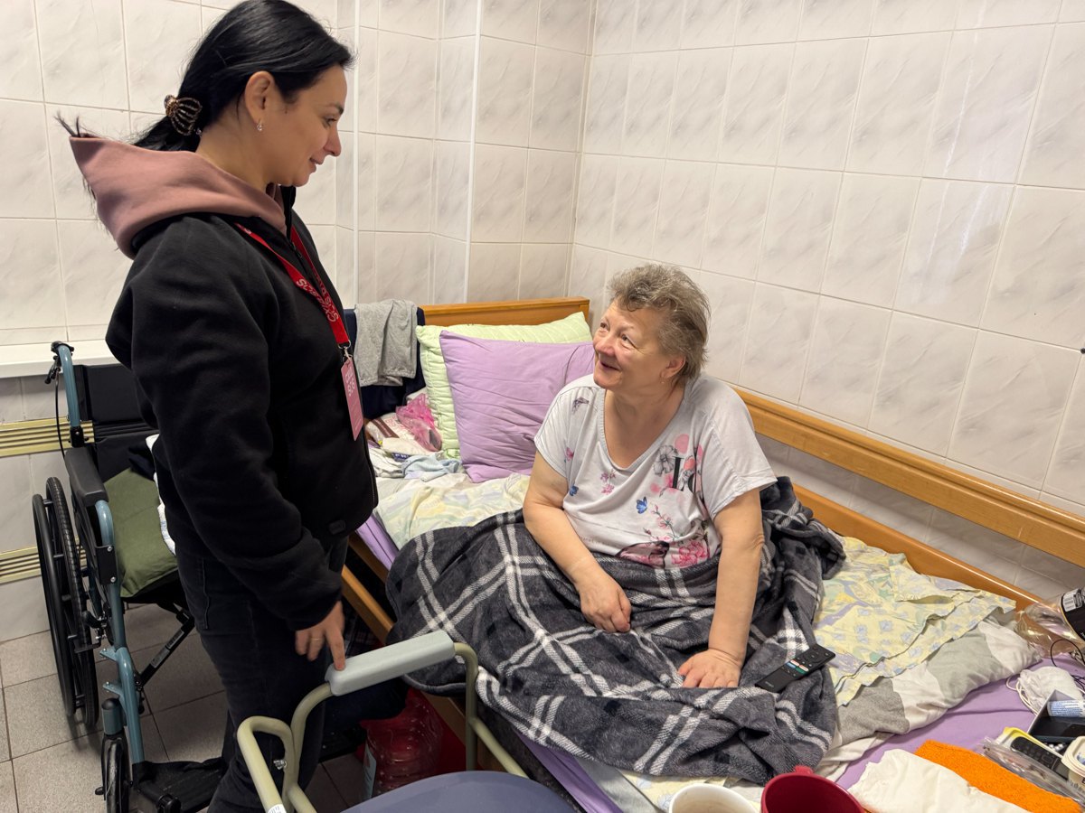 Social worker Oksana communicates with a woman evacuated from Lyptsi, Kharkiv Region