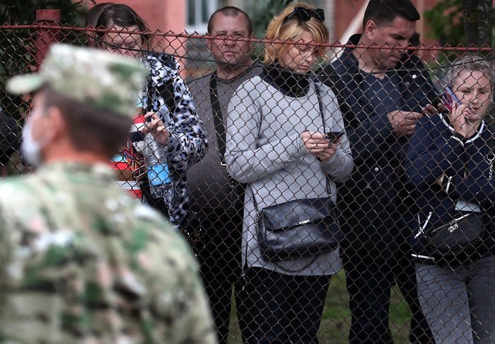 People gather near the prison where their relatives who took part in the protests are being held.