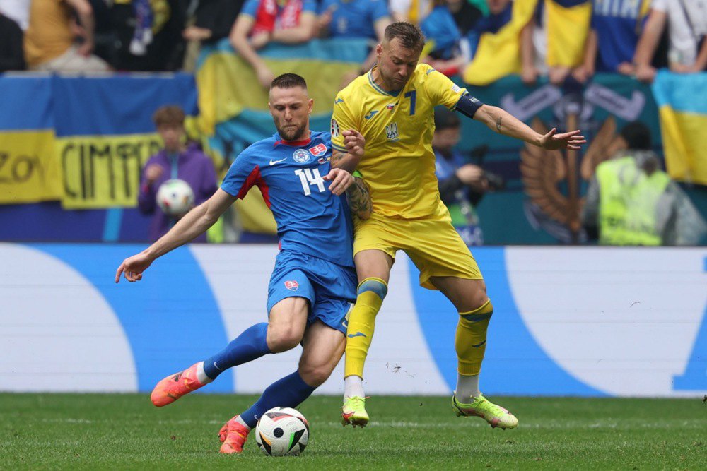 Andriy Yarmolenko (right) fights for the ball against Milan Škrinjar in the Slovakia vs Ukraine match at Euro 2024